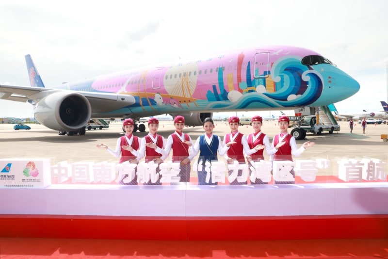 Full view of the finished aircraft presented by employees from China Southern Airlines.