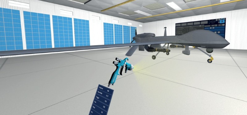 A virtual reality view of a paint simulator showing a digital spray gun aimed at an unmanned aerial vehicle (drone) inside a virtual hangar. On-screen spray gun settings are displayed.