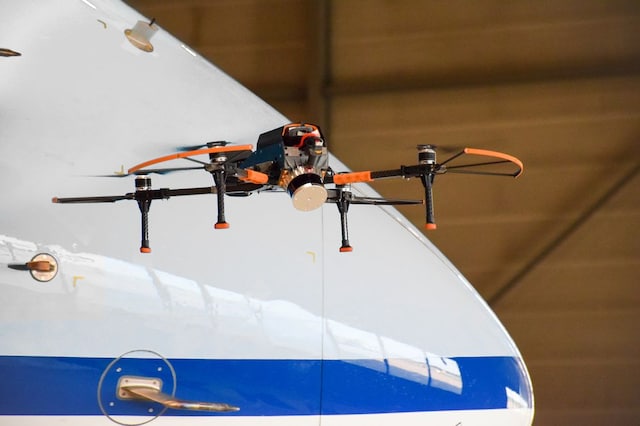 Drone inspecting airplane
