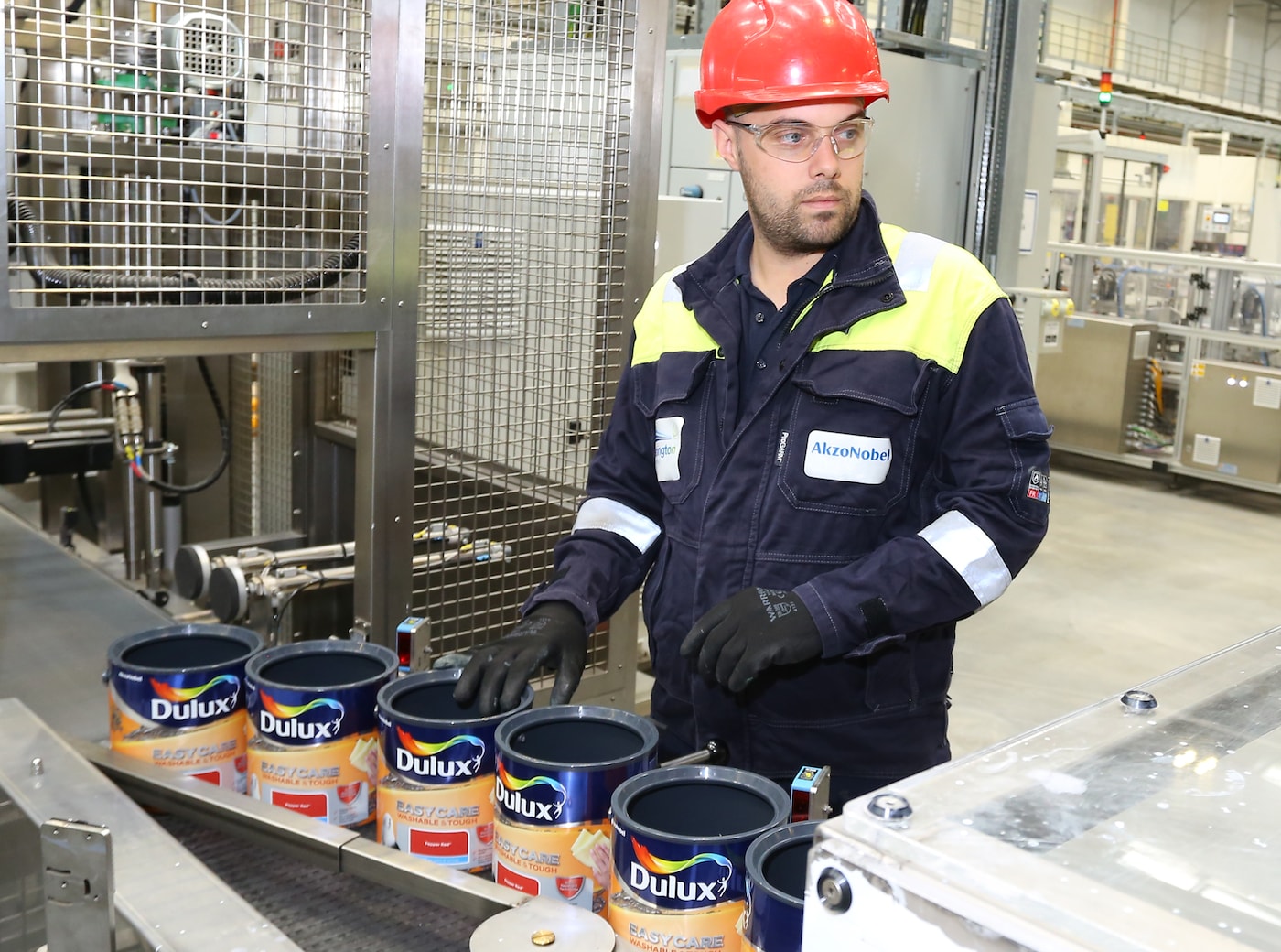 An AkzoNobel employee monitors Dulux Easycare paint production at the company's Ashington manufacturing site in the UK