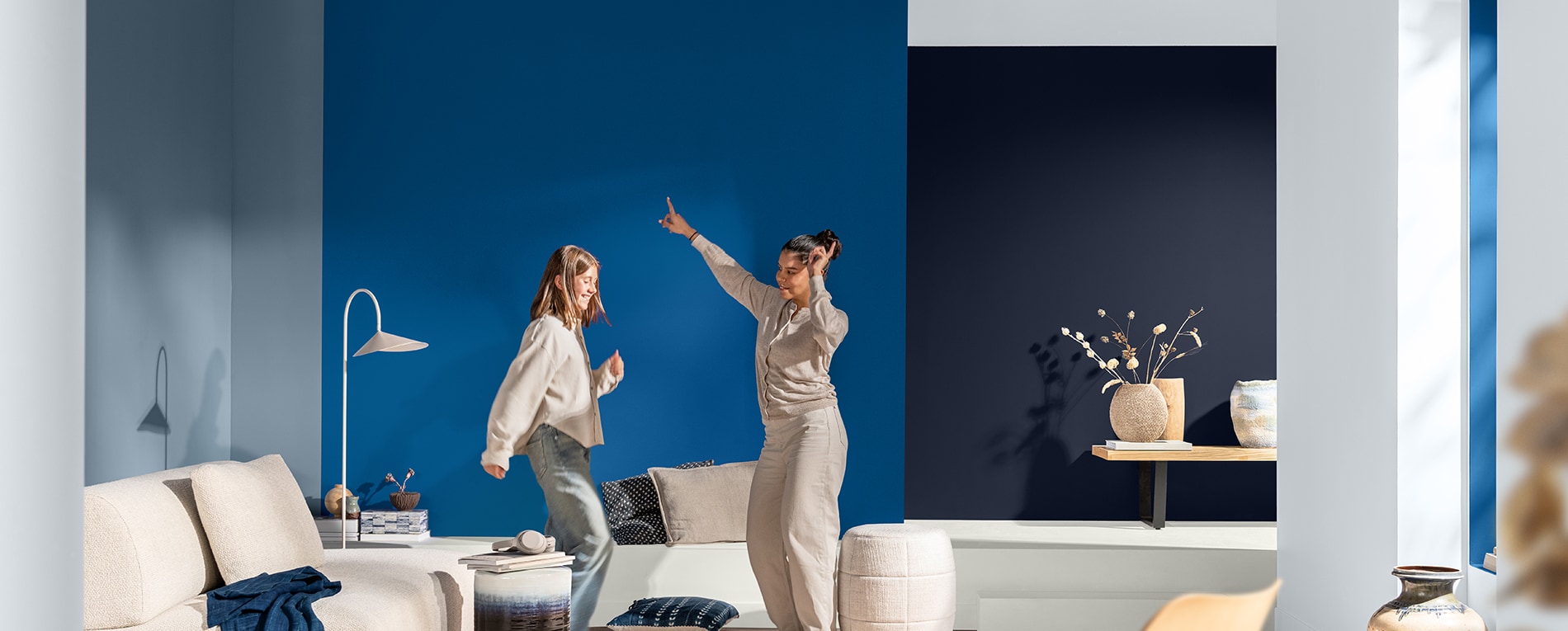 People dancing in a living room with true joy paint color on the wall