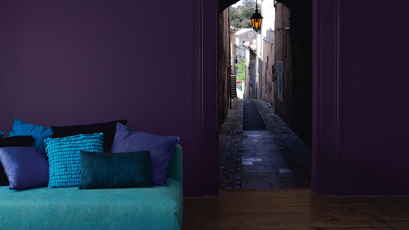 Living room decorated in striking shades of purple, teal and turquoise.
