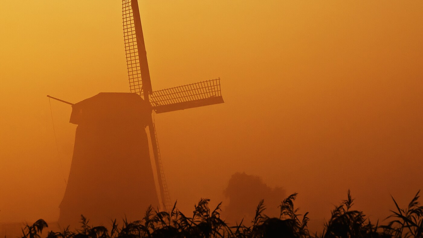 Dutch windmill in orange sunset