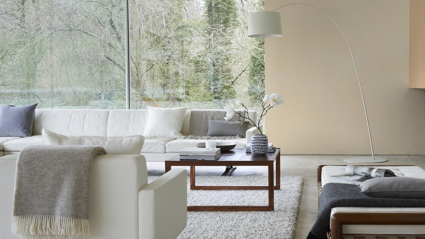 Create a stylish, modern living room by painting walls with different hues of warm neutrals and adding furniture in cool neutrals.