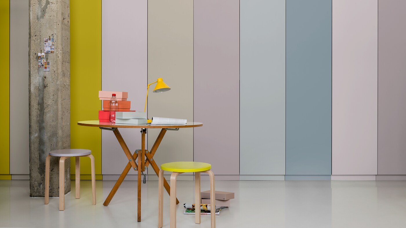 A striped feature wall with a bold accent yellow against subtler hues.