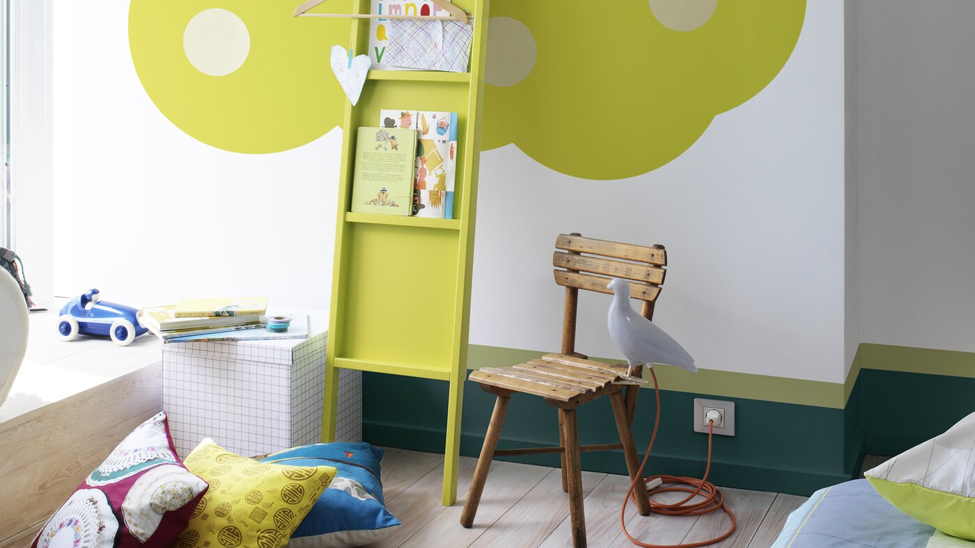 Bright green tree painted in children’s room