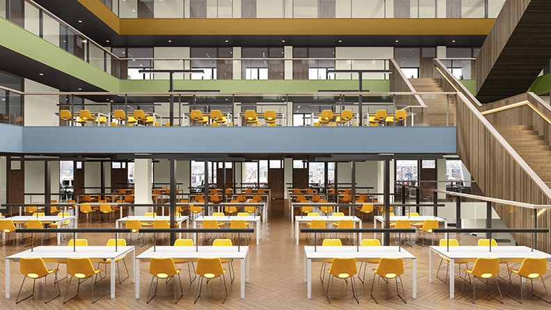 Åbent klasseværelse med øvre balkoner malet i blåt, grønt og gult