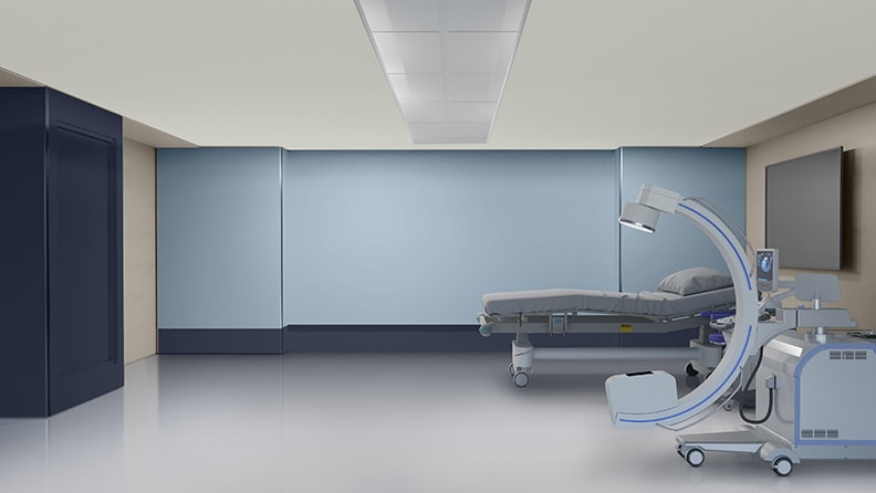 Behandlingsrum med blå bagvæg og hospitalsseng