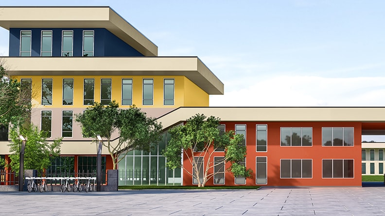 Facaden på en skole er malet i gul, blå og orange