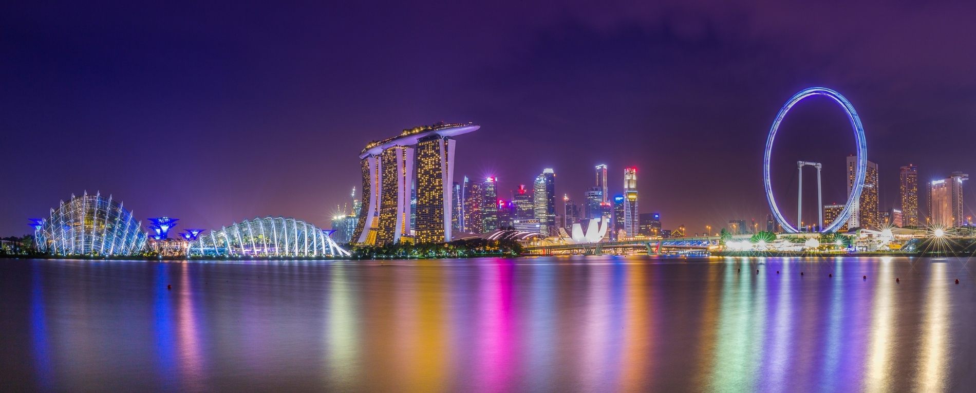Singapore skyline at night featuring Marina Bay Sands, Gardens by the Bay and the Singapore Flyer, host city of MRO Asia-Pacific 2026.