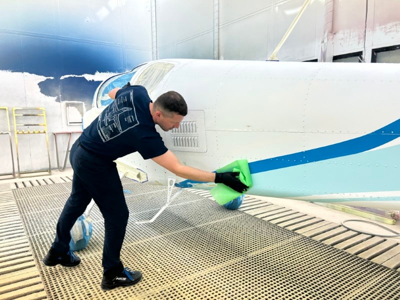 A technician wipes the fuselage with a rag while preparing    for the next step in the coating process.