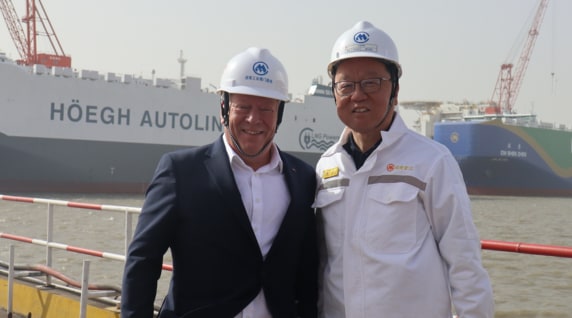 Two men shaking hands in an office setting