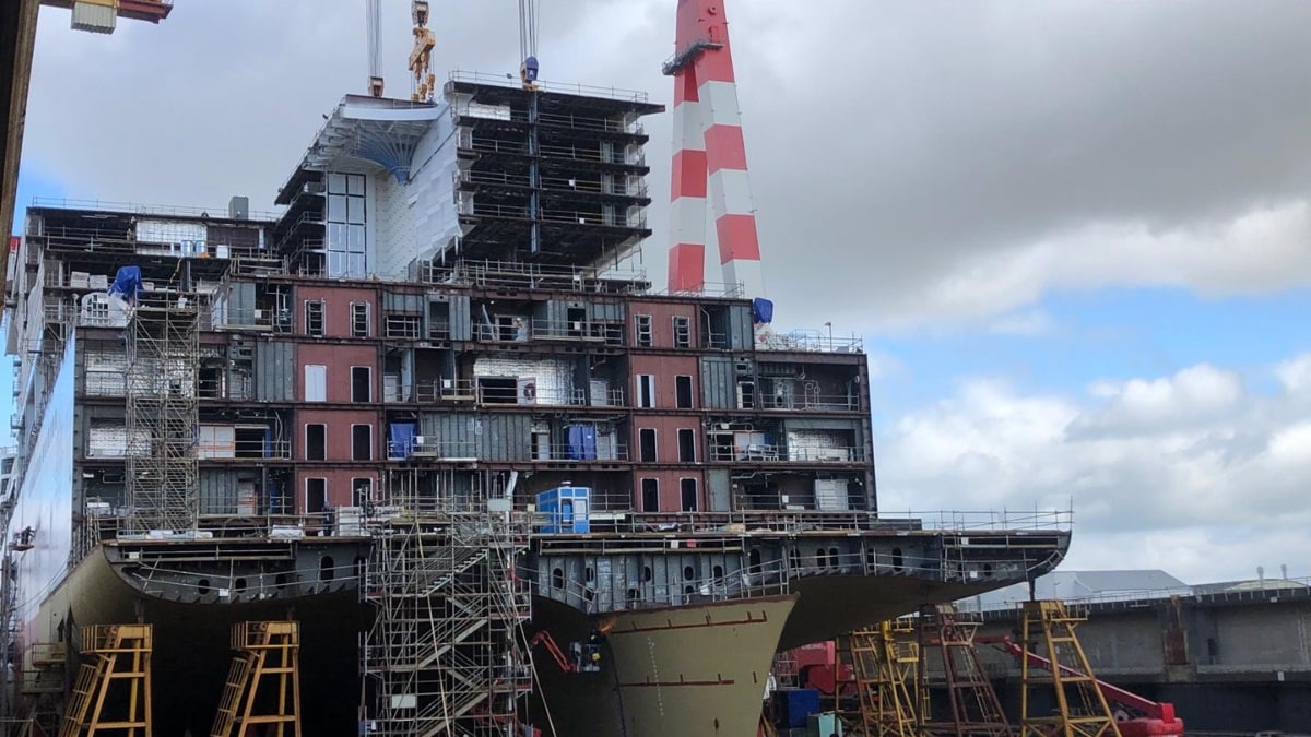 Vessel under construction at the CDA shipyard, supported by scaffolding and a gantry crane. 
