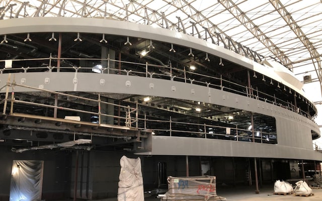 Interior block structure showing completed coating and scaffolding on upper levels.
