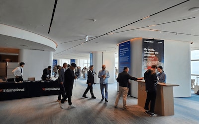 Delegates arriving and networking at the International Marine Coatings registration area.