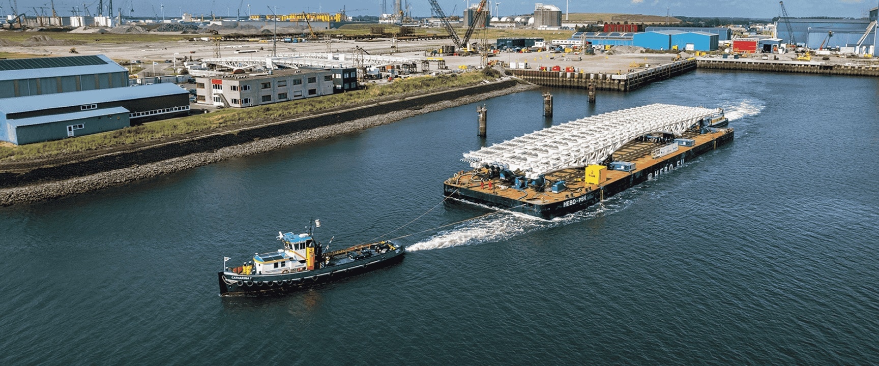 A barge transporting steel bridge sections for the IJburg Bridges project in Amsterdam.