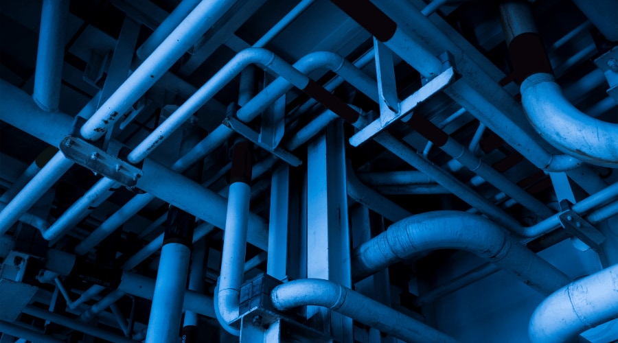 Close-up of industrial piping system with protective coating applied to steel surfaces.