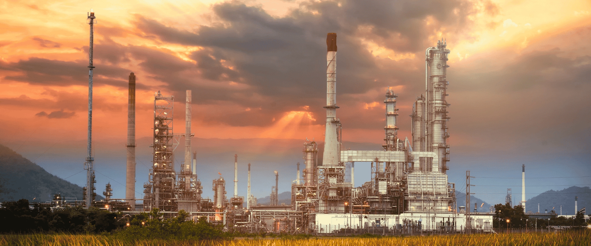 Industrial plant at sunset highlighting CUI maintenance and cyclic temperature solutions.