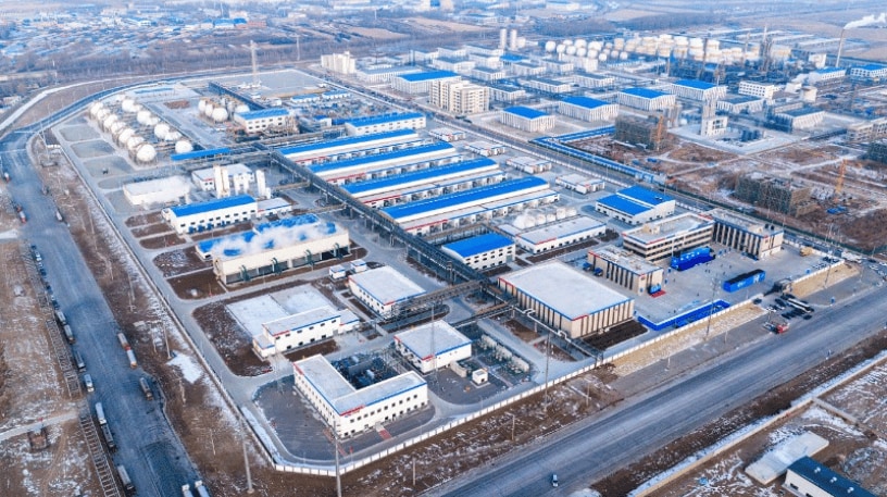 Aerial view of the Songyuan Hydrogen Energy Industrial Park in China, showing industrial buildings, hydrogen storage tanks and renewable energy infrastructure.