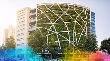 Modern building façade with plants supported by a white geometric structure
