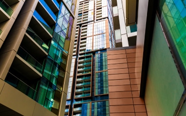 Staircase with golden powder-coated panels and glass walls