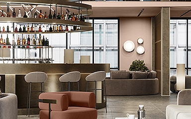 Modern lounge with a circular metal bar, blue window frames, and upholstered sofas.