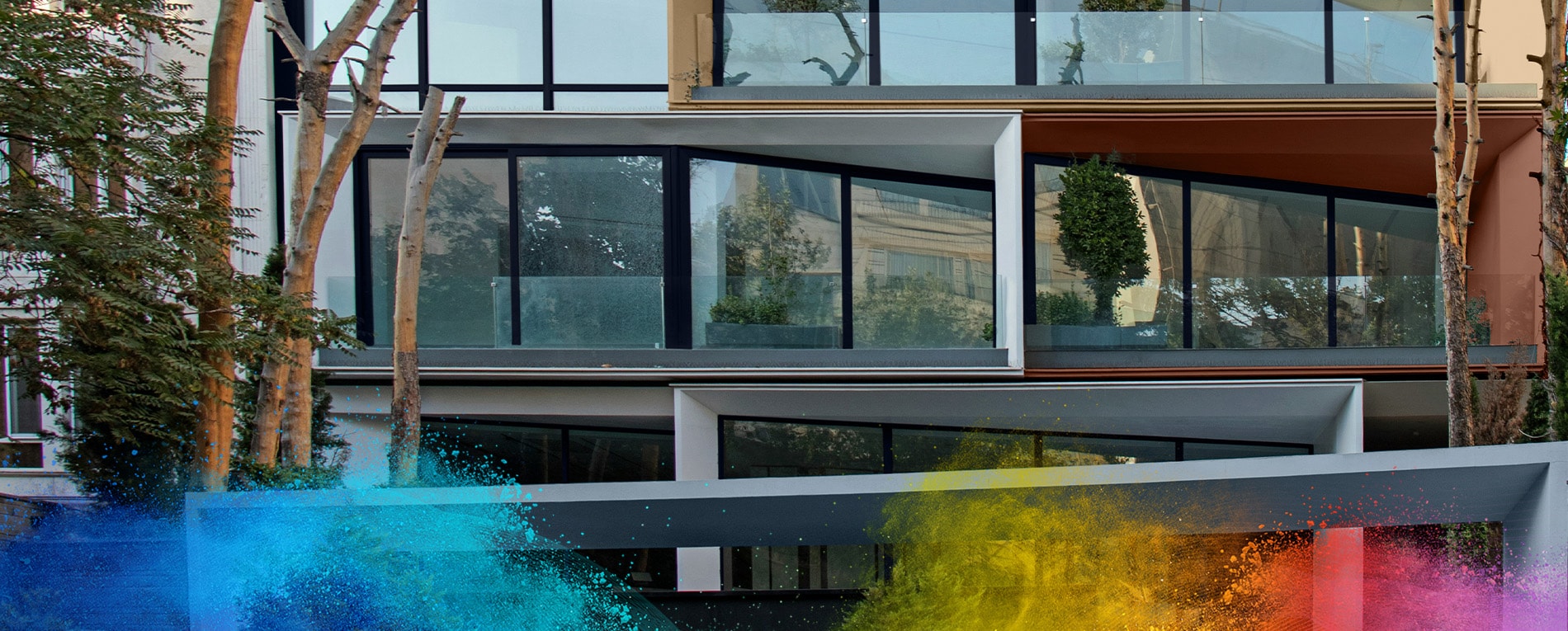 Modern building facade with large blue-framed windows and angled balcony structures.