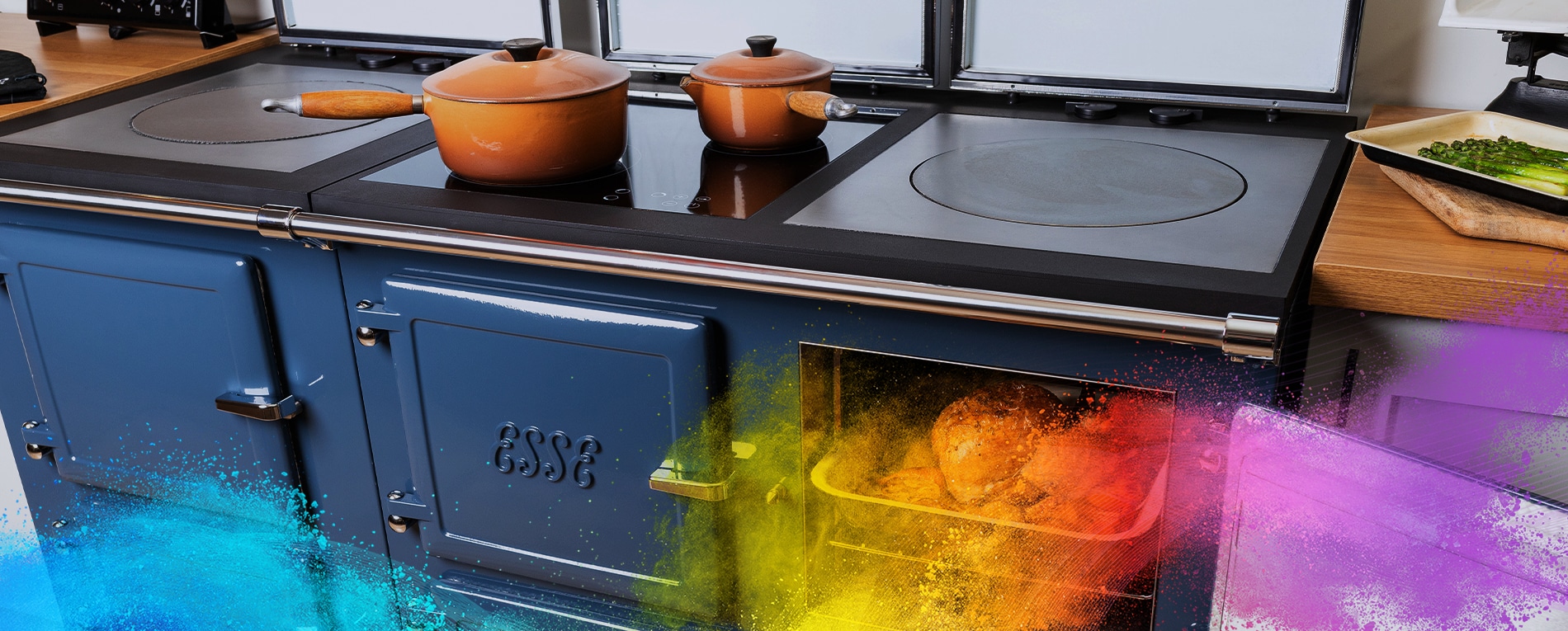 Blue ESSE cooker with food roasting in the oven and pots on the stovetop