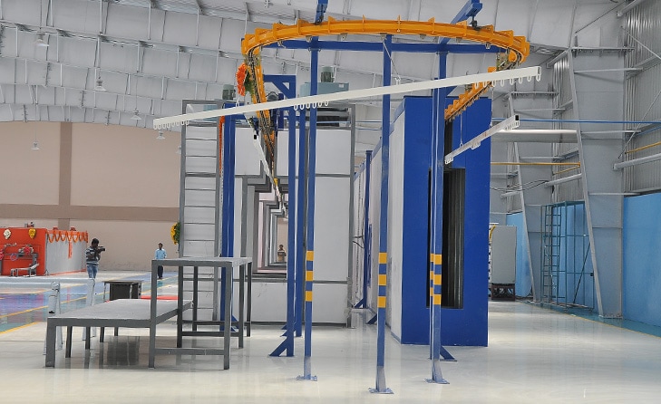 Powder coating line inside a modern industrial coating facility