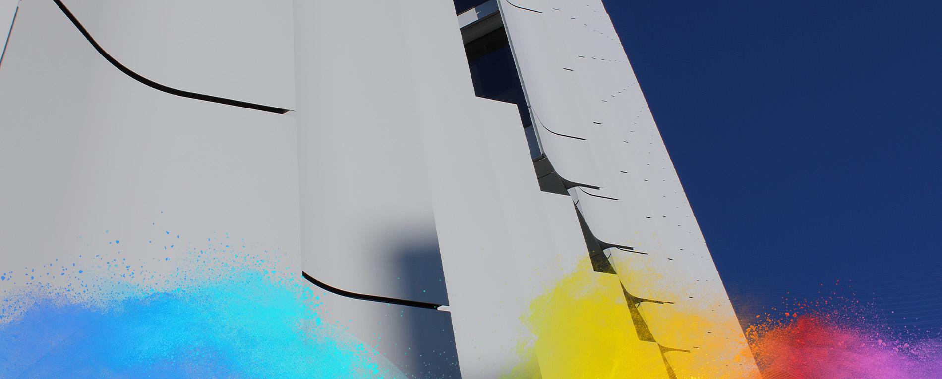 Close-up of white metal panel facade with vertical cuts against blue sky.