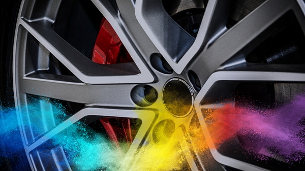 Close-up of an alloy wheel with a red brake caliper.