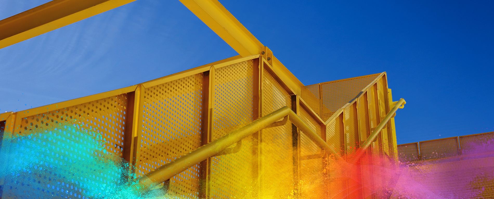 Yellow metal stairs with perforated panels, coated using low cure powder coating technology