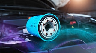 Blue oil filter on a car engine with the hood open