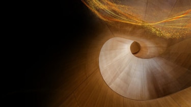 Curved wooden structure with warm lighting accents.