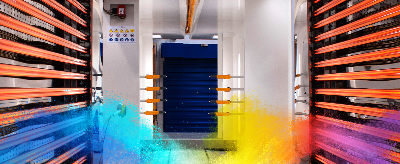 Interior view of a powder coating booth, showing precision equipment for an efficient coating process