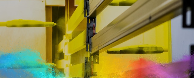 Powder coating process with yellow spray guns.