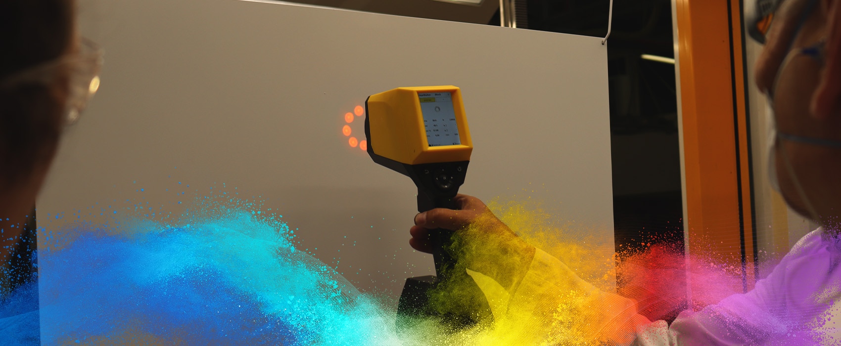 Technician using a handheld device to measure coating thickness on a white surface during a quality control process