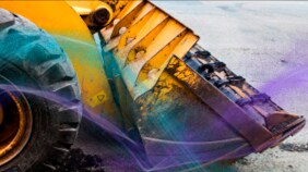 A construction vehicle's front loader with a yellow powder coating