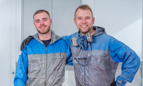 Applicators posing together in protective gear