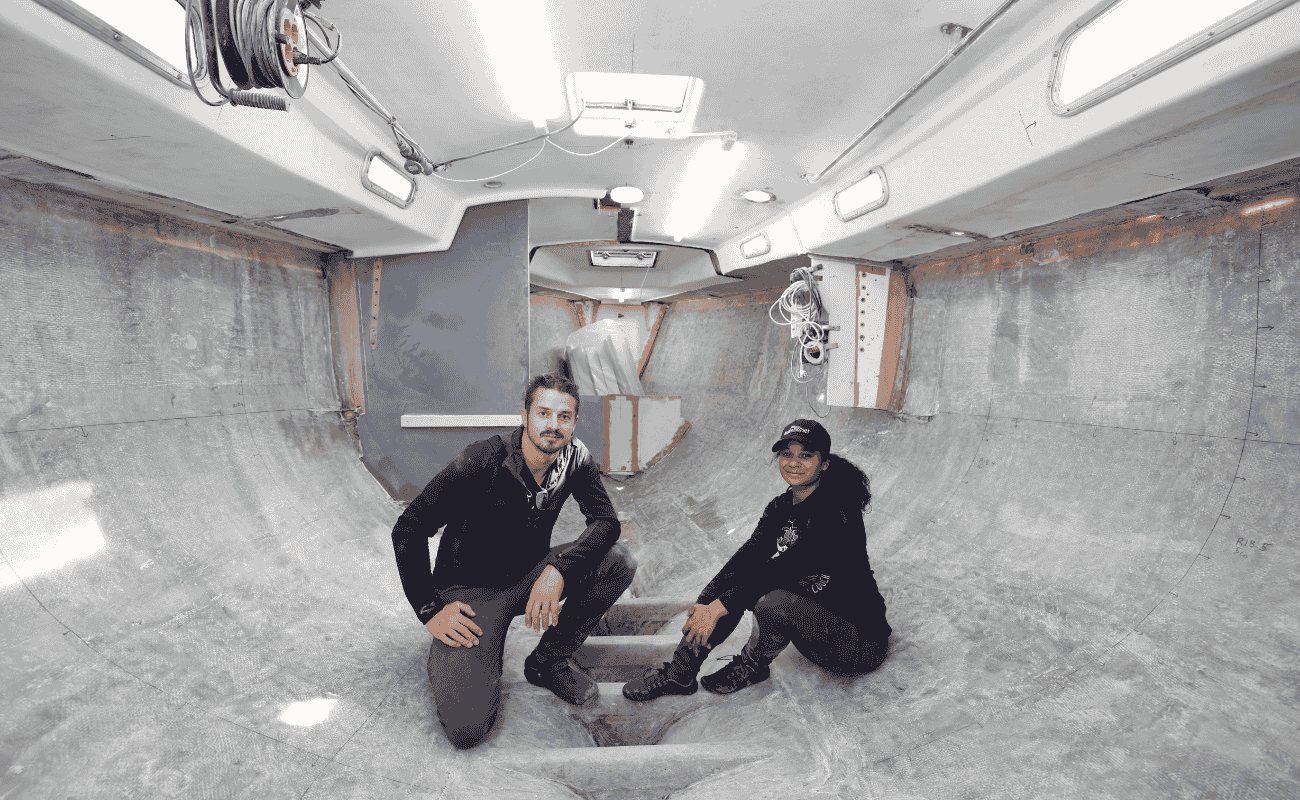 Dan and Kika inside their stripped sailboat