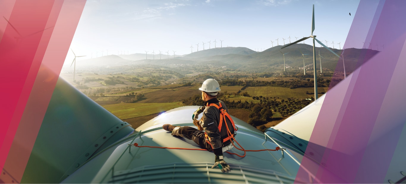 Man sitting on top of a windmill after working