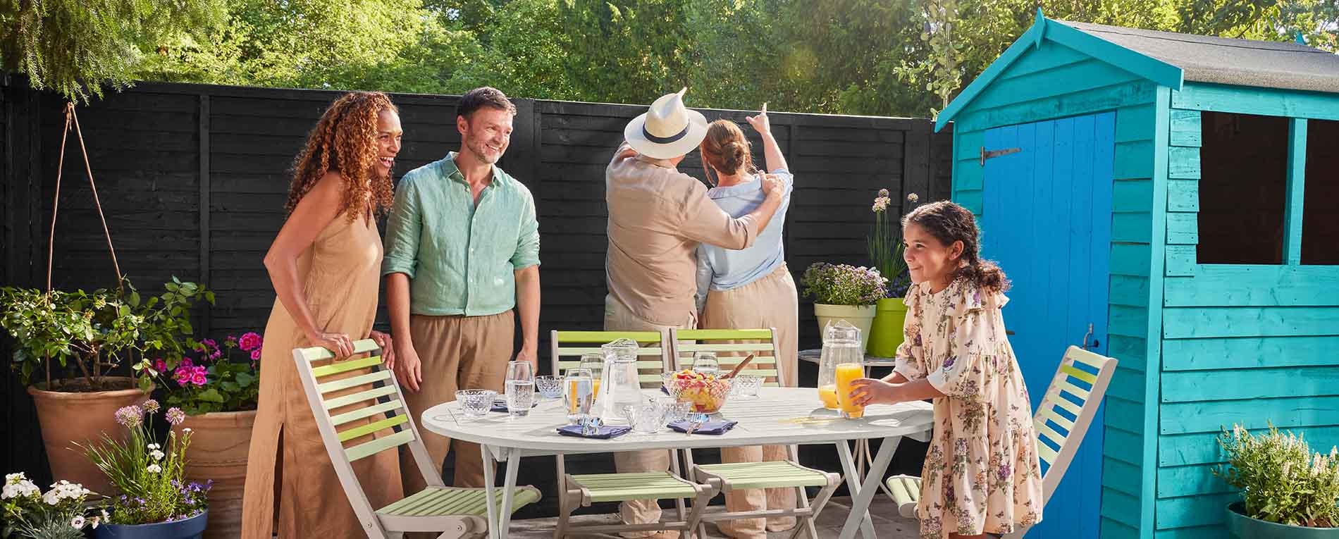 Image of a family enjoying outdoors in their garden painted in Cuprinol products