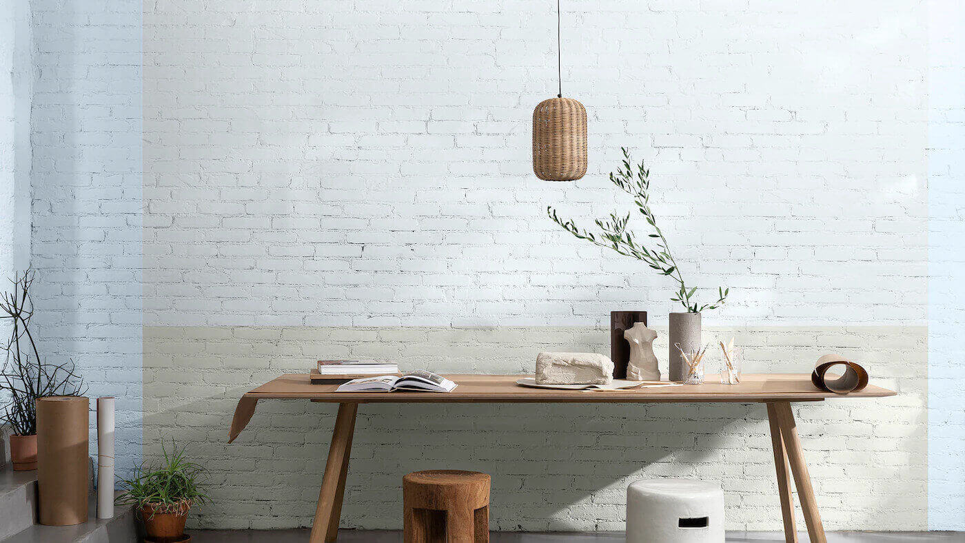 Quarto de casal decorado com a cor Melodia Suave da Tintas Coral. A entrada de luz no ambiente é realçada através da combinação entre o tom verde Cáqui Intenso e o tom Mergulho Sereno, além do destaque da cor do ano Melodia Suave no teto e na parte superior da parede. 