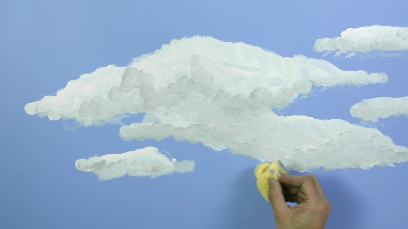 Use duas esponjas para criar dar efeito às nuvens. Mergulhe uma delas em Linho Claro e suavize os cantos das nuvens