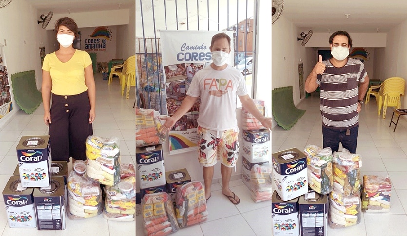 Pessoas recebendo as doações de alimentos em parceria com as Tintas Coral.