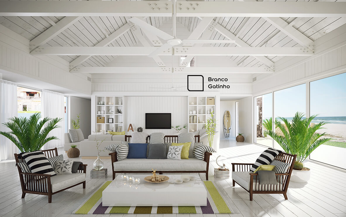 Sala de estar praiana na cor Branco Gatinho da Tintas Coral. Pintura funciona bem com elementos naturais em abundância, como madeira e tecidos de algodão.