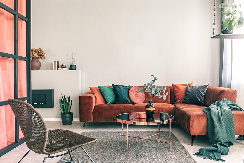 Sala decorada com sofá combinando com cor da parede.