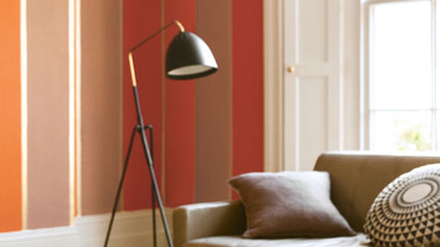 Herbstliche Rottöne in verschiedenen Abstufungen verleihen dem Raum Wärme und Authentizität.