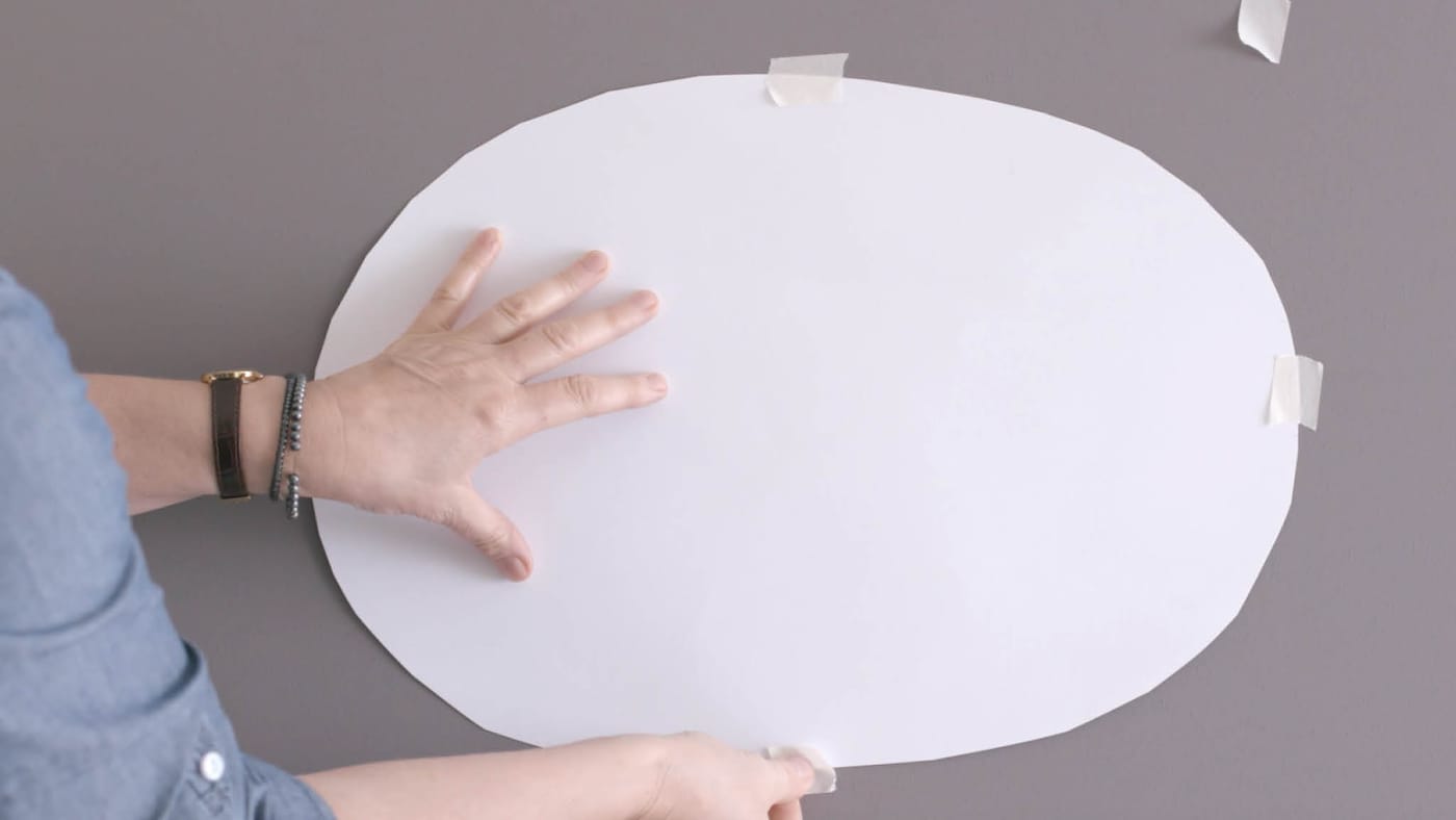 Tape your oval to the area you’d like to paint
