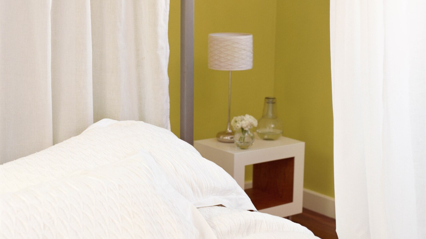 A curtain suspended from the ceiling that draws around the crib is an easy way to create a makeshift “room” and give both baby and your guest a little privacy.